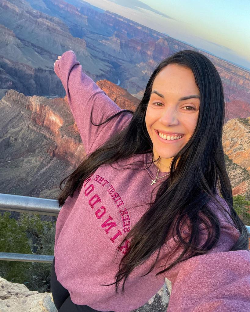 Woman smiling at the Grand Canyon.