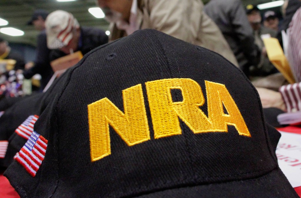 Black baseball cap with gold NRA embroidery.