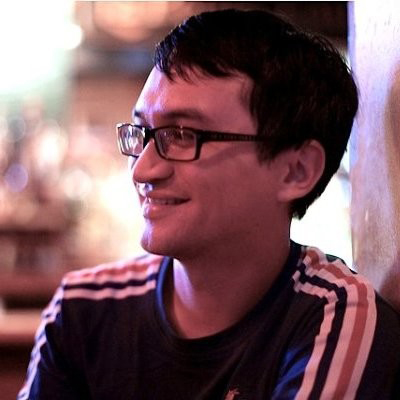 Man wearing glasses smiling.