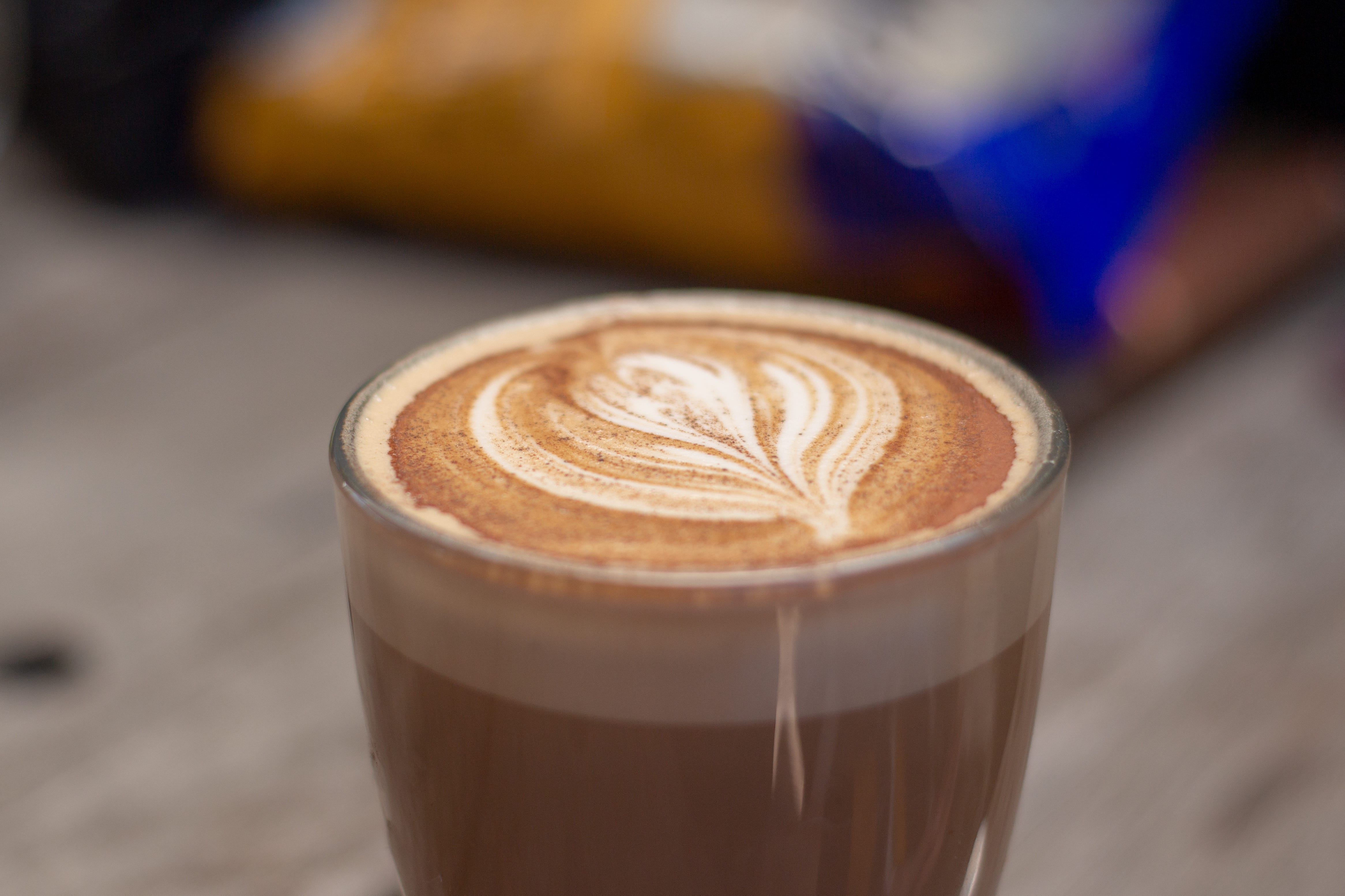 A close-up photo of a dirty chai latte with art.