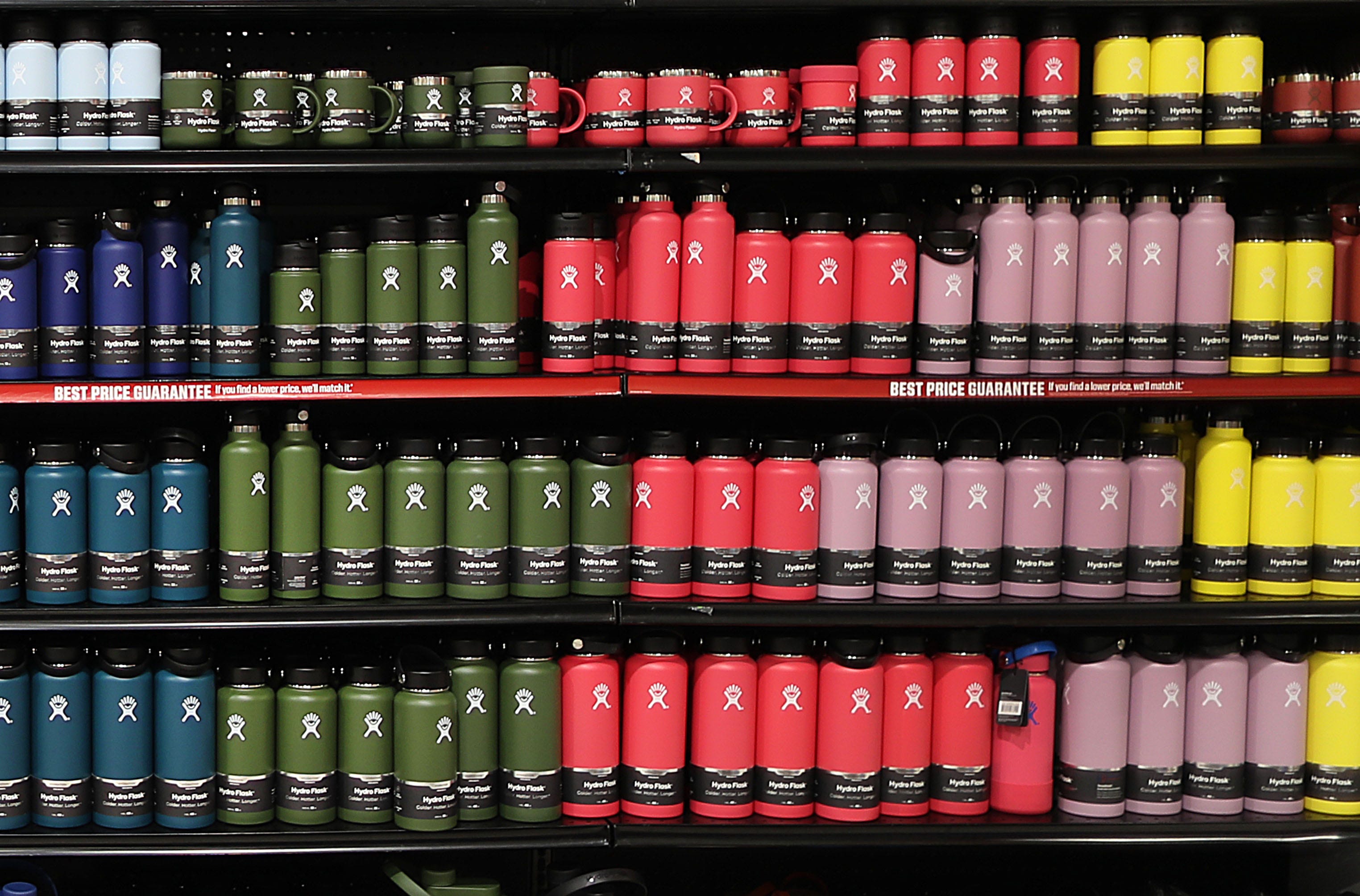 A row of Hydro Flask water bottles on a store shelf.