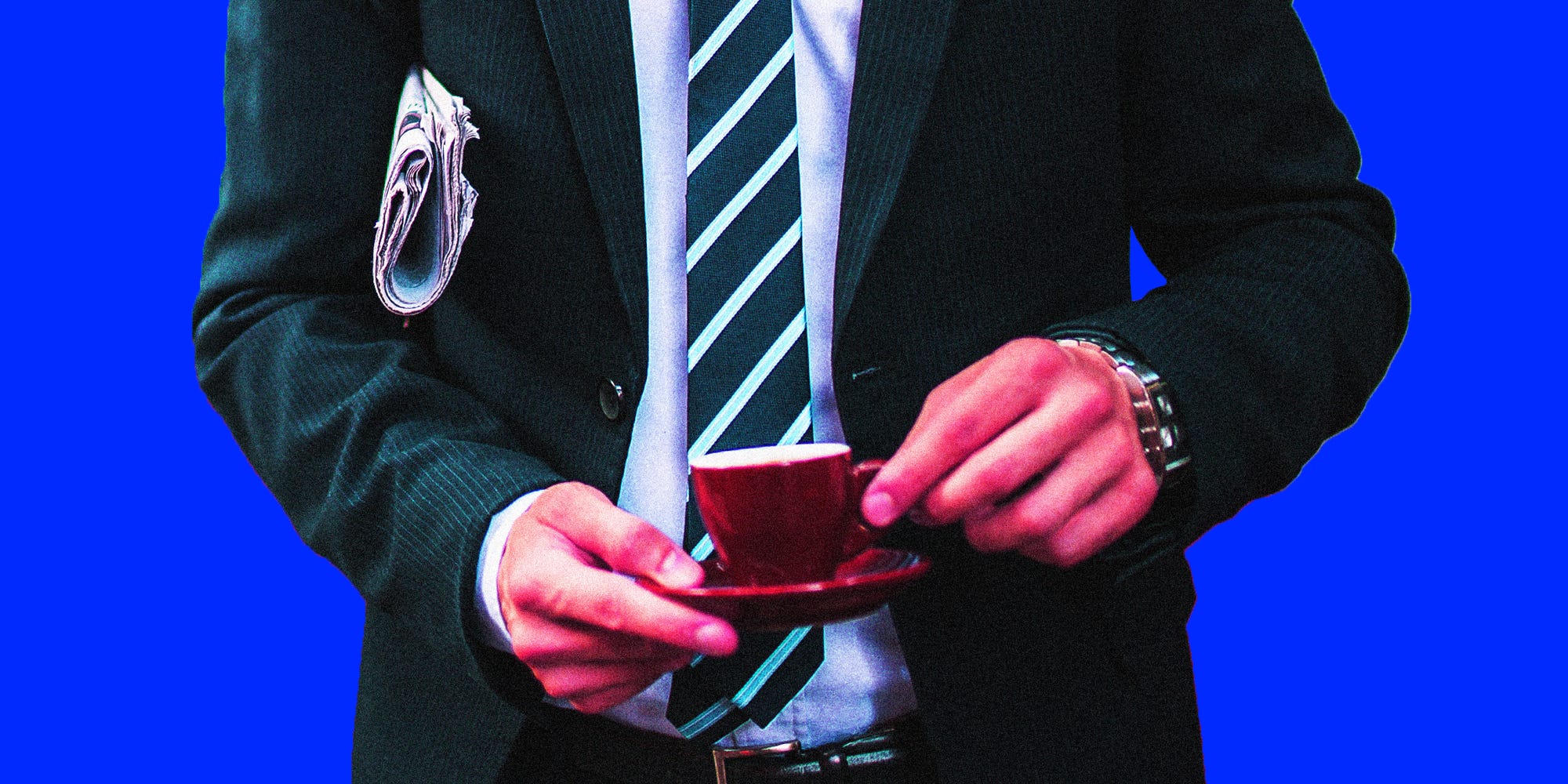 A businessman holding a newspaper and an espresso cup