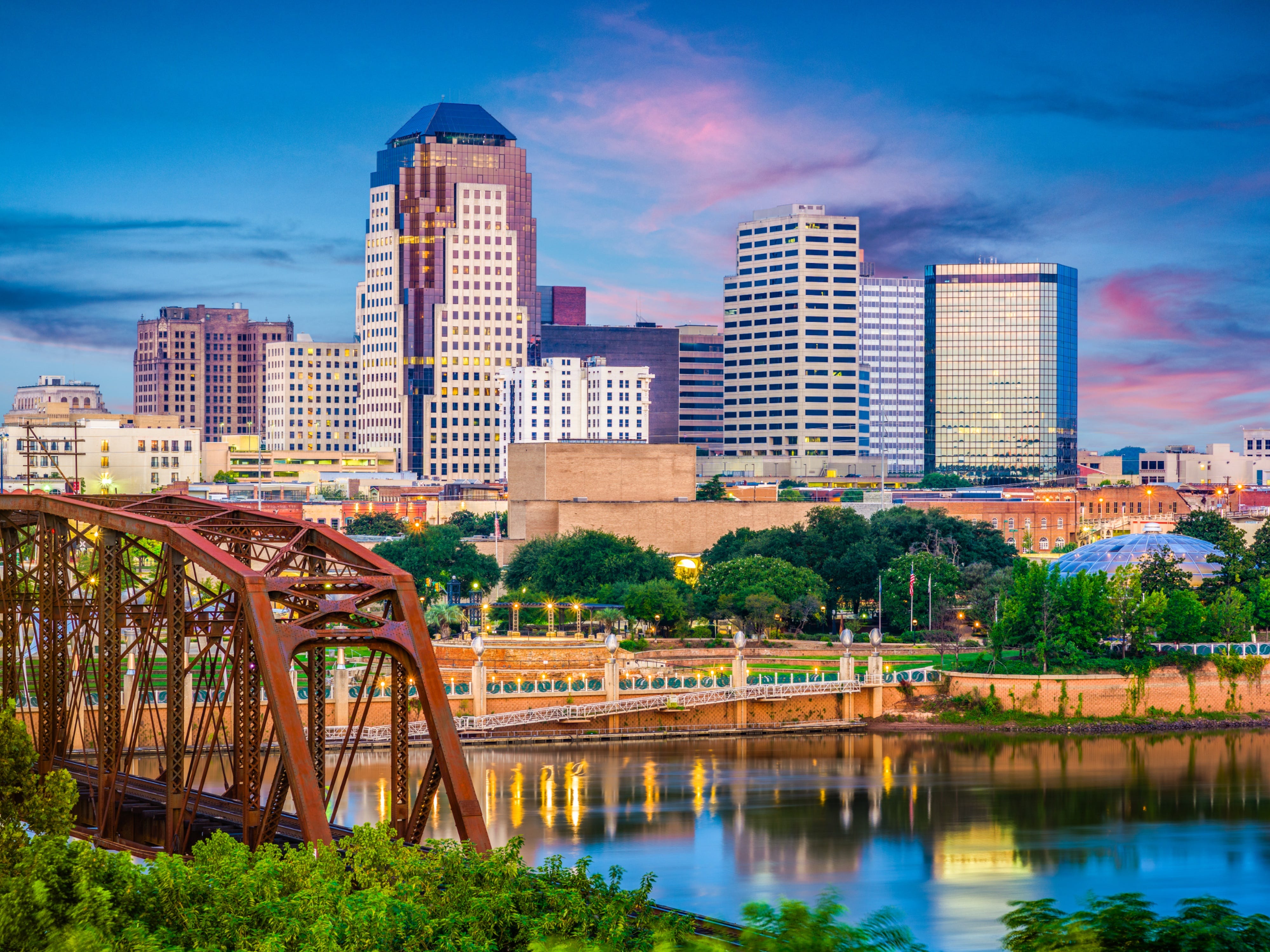 The skyline of Shreveport, Louisiana, over the Red River at dusk.