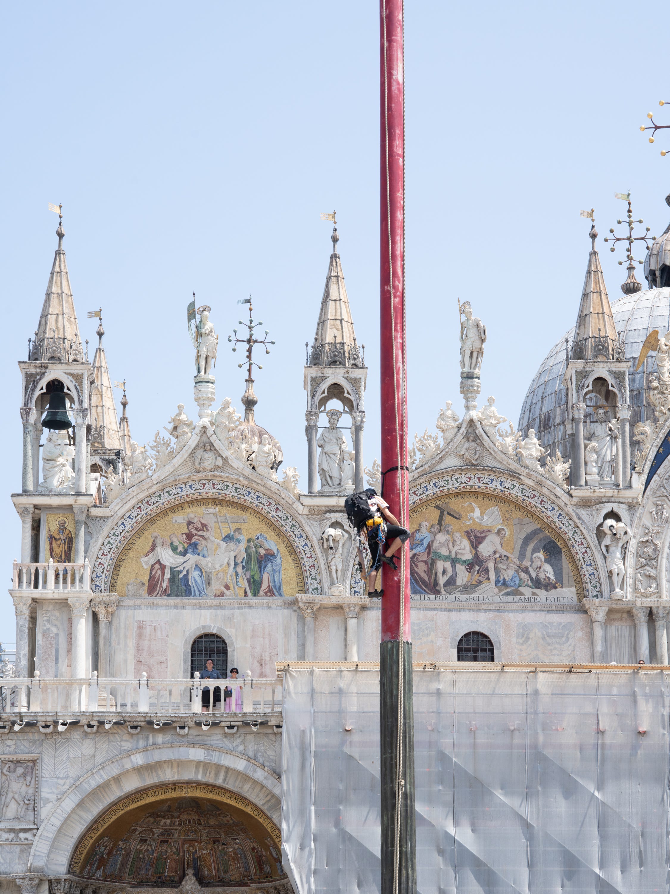 A protester climbing a pole