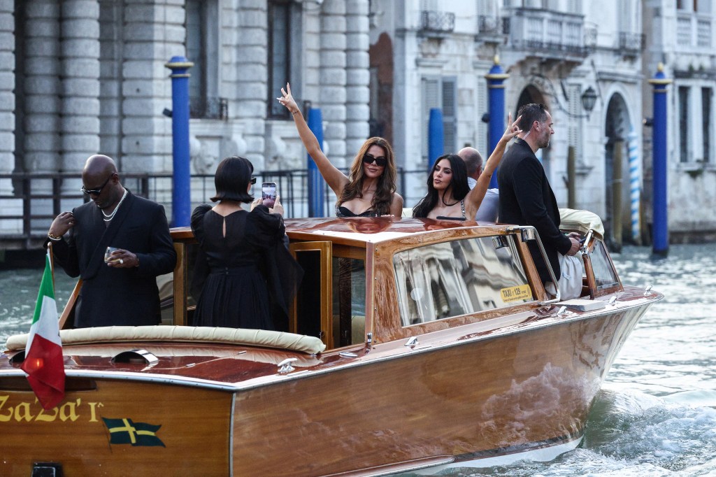 Kris Jenner takes a picture of Khloe Kardashian and Kim Kardashian on a boat.