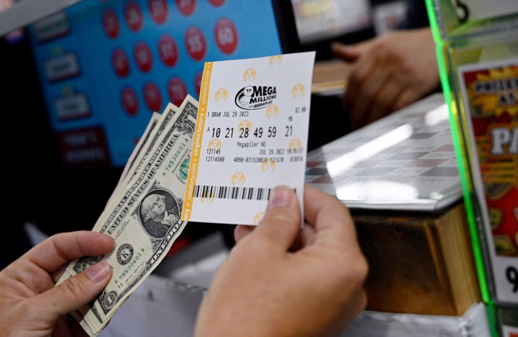 A person buys a Mega Millions lottery ticket at a store in Arlington, Virginia on July 29, 2022.