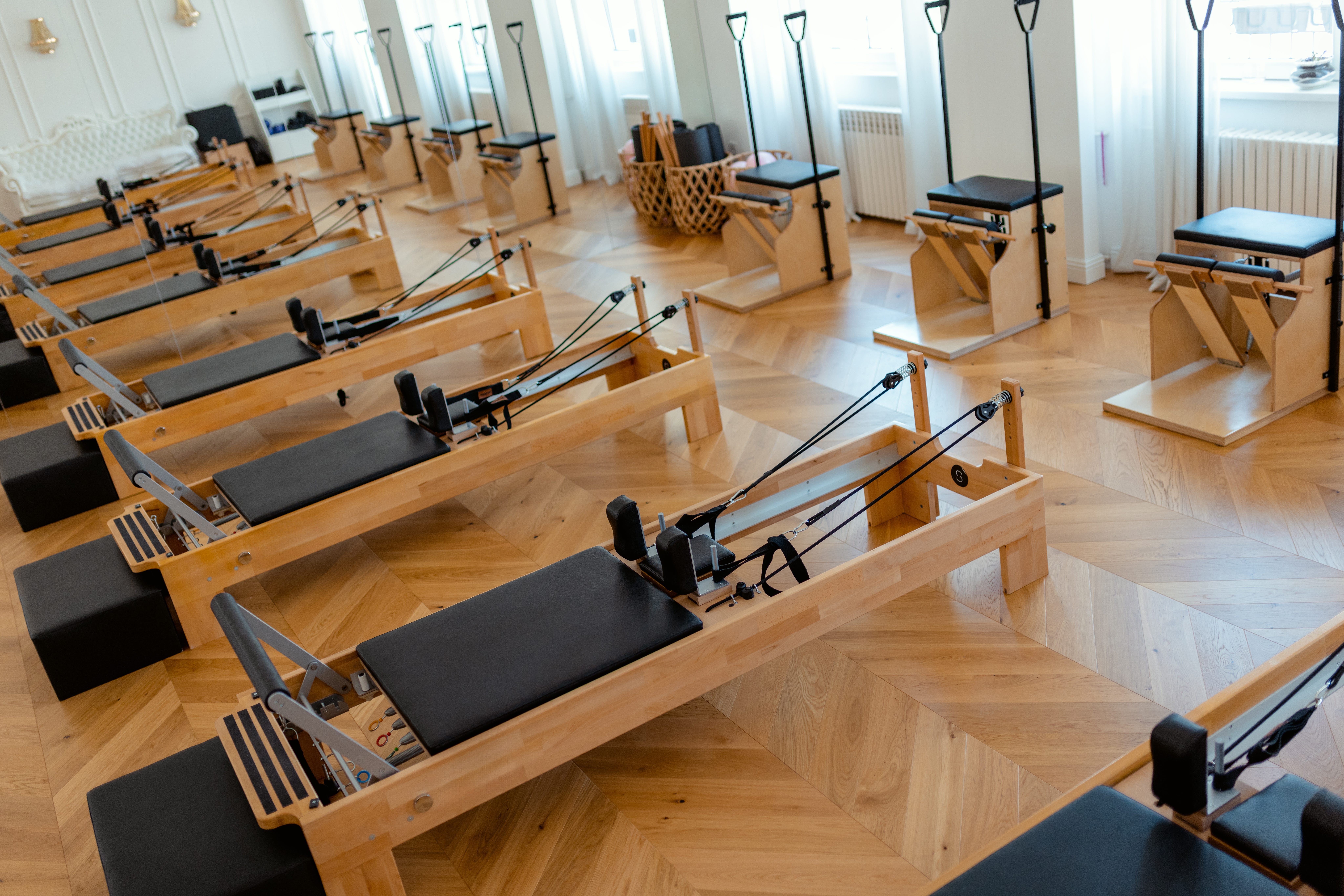 Pilates can be done on a mat or on a reformer machine, like this.