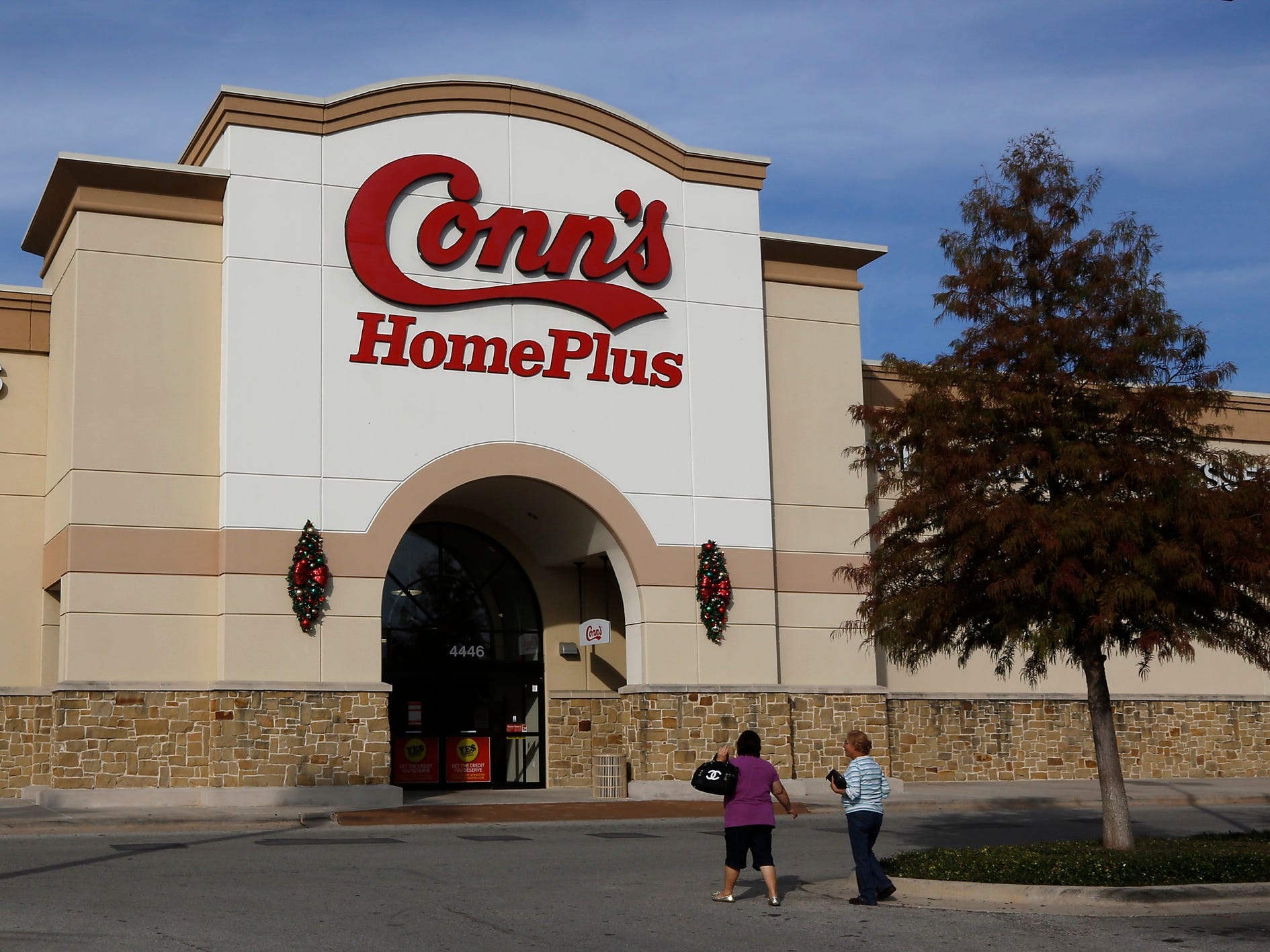 Shoppers in front of a Conn's Home Plus store in Texas