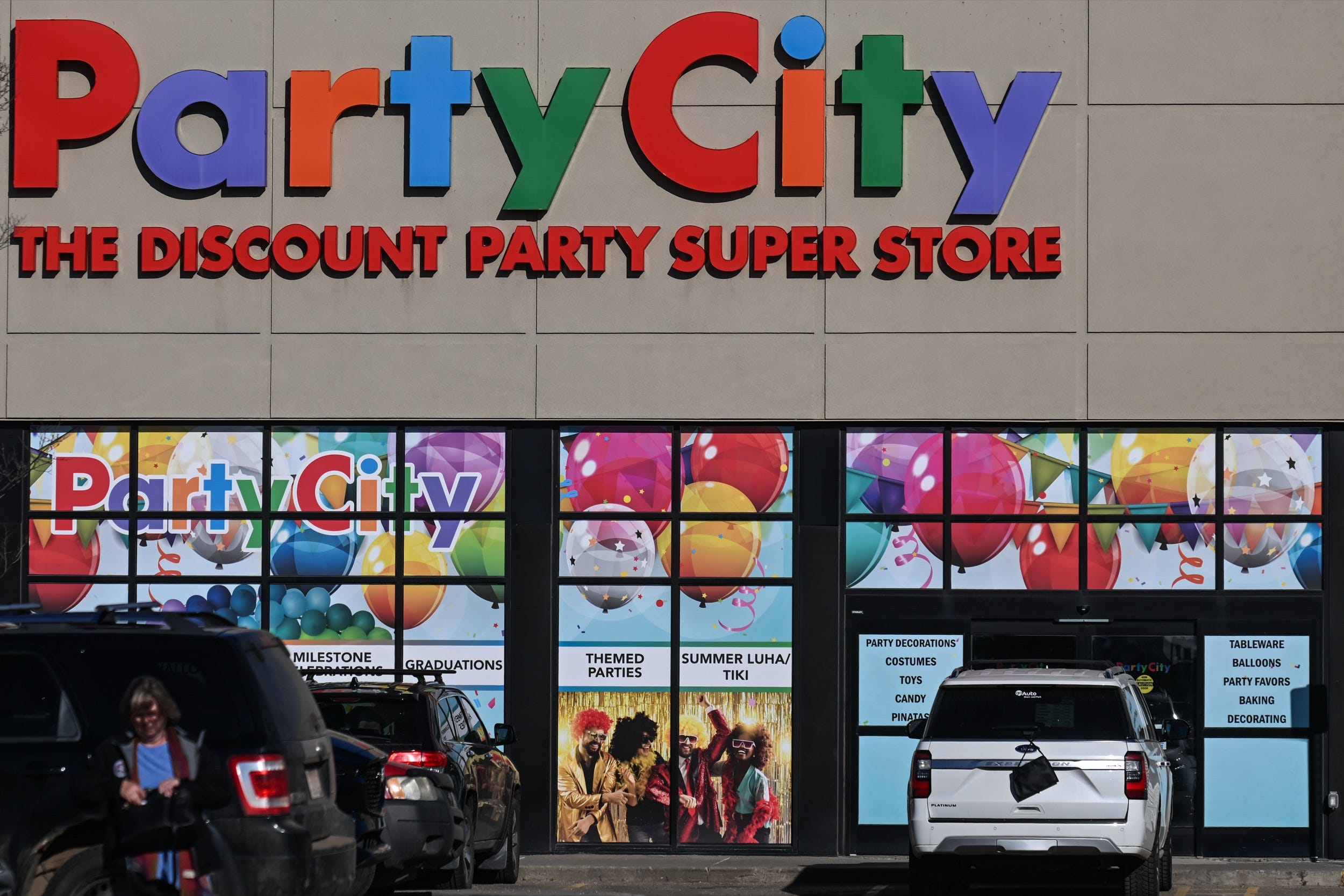 Vehicles are parked in front of a Party City in Alberta, Canada.