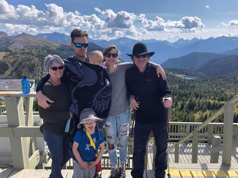 The author and her family visiting with Fern and Billy in front of a mountain view.