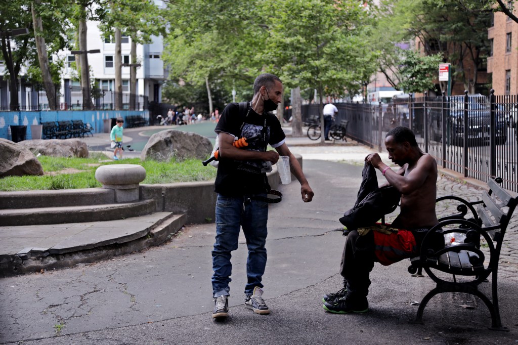Two men interacting in a park.