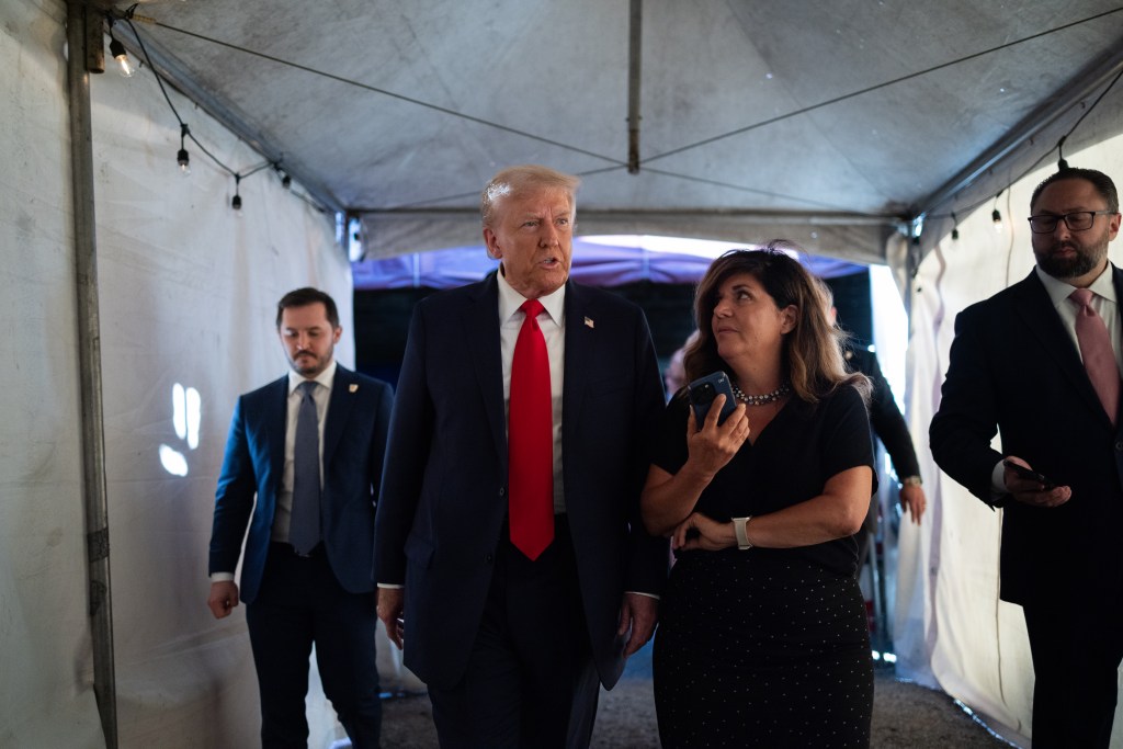 Donald Trump and Salena Zito walking and talking.