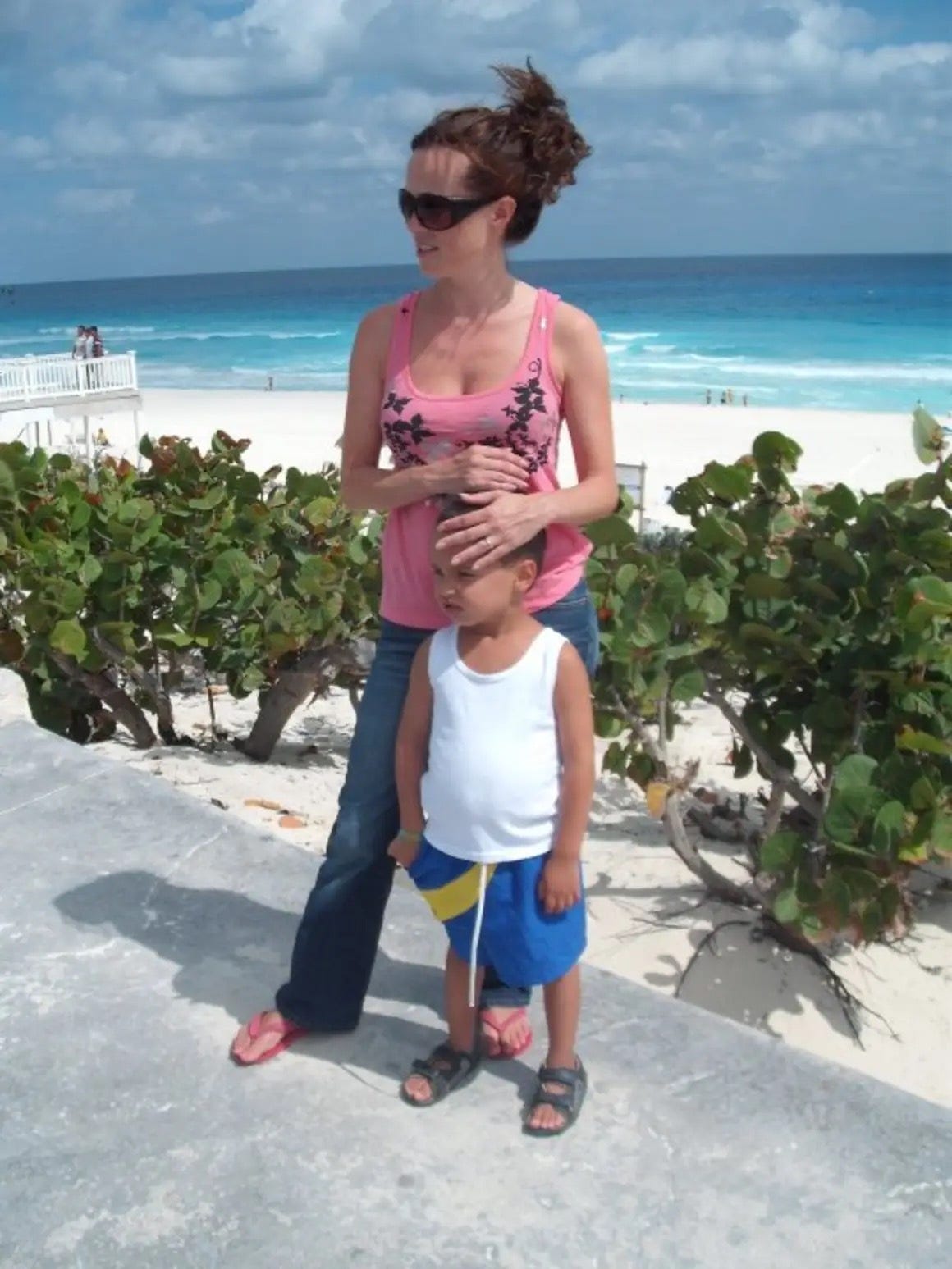 Woman by the beach with child