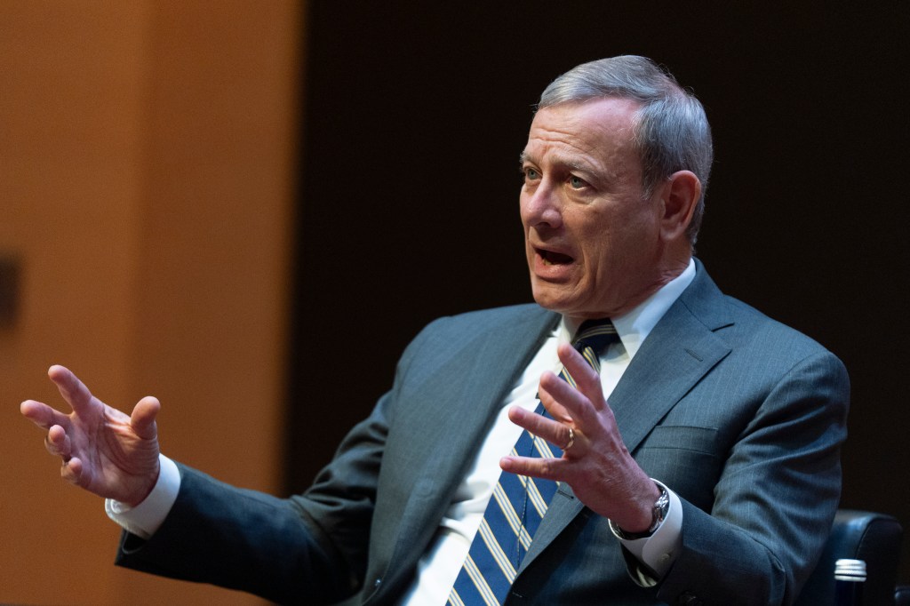 John Roberts speaking at a lecture.