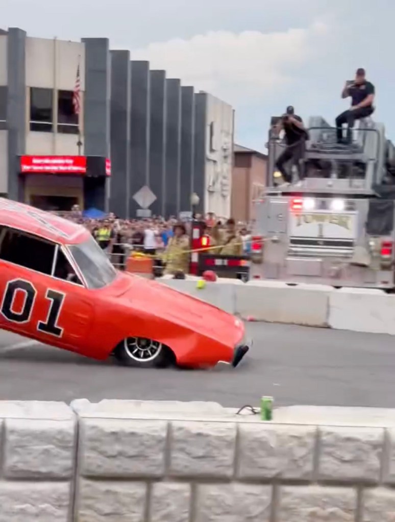 A Dukes of Hazzard replica car jumping over a fountain.