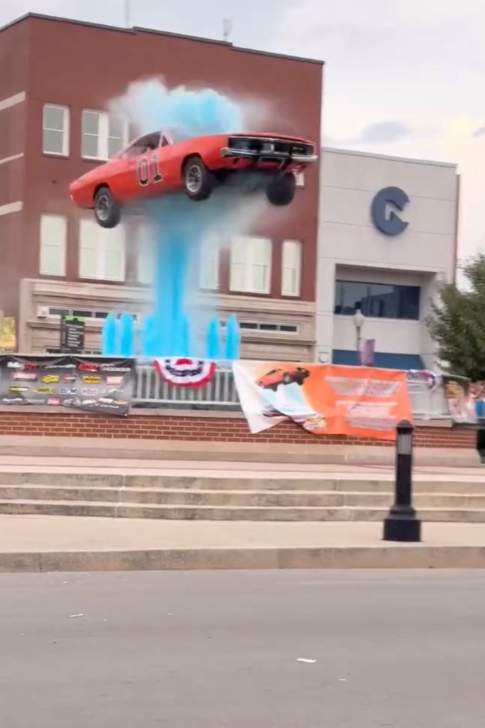 A General Lee replica car jumping over a fountain.