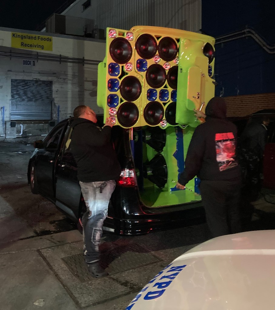 NYPD officers approaching a vehicle equipped with speakers in Greenpoint, Brooklyn.