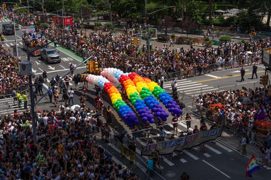 NYC Pride march with rainbow balloons.