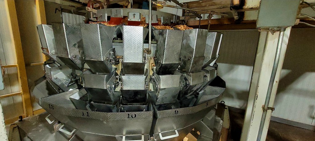 Interior view of a multi-head weigher in a food processing facility.