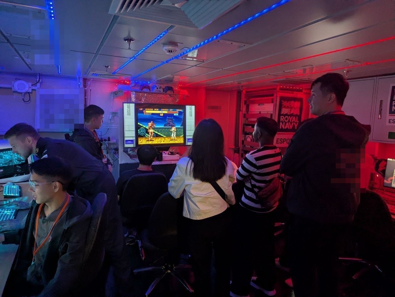 Singaporean citizens try out the Royal Navy's gaming suite on the HMS Prince of Wales.