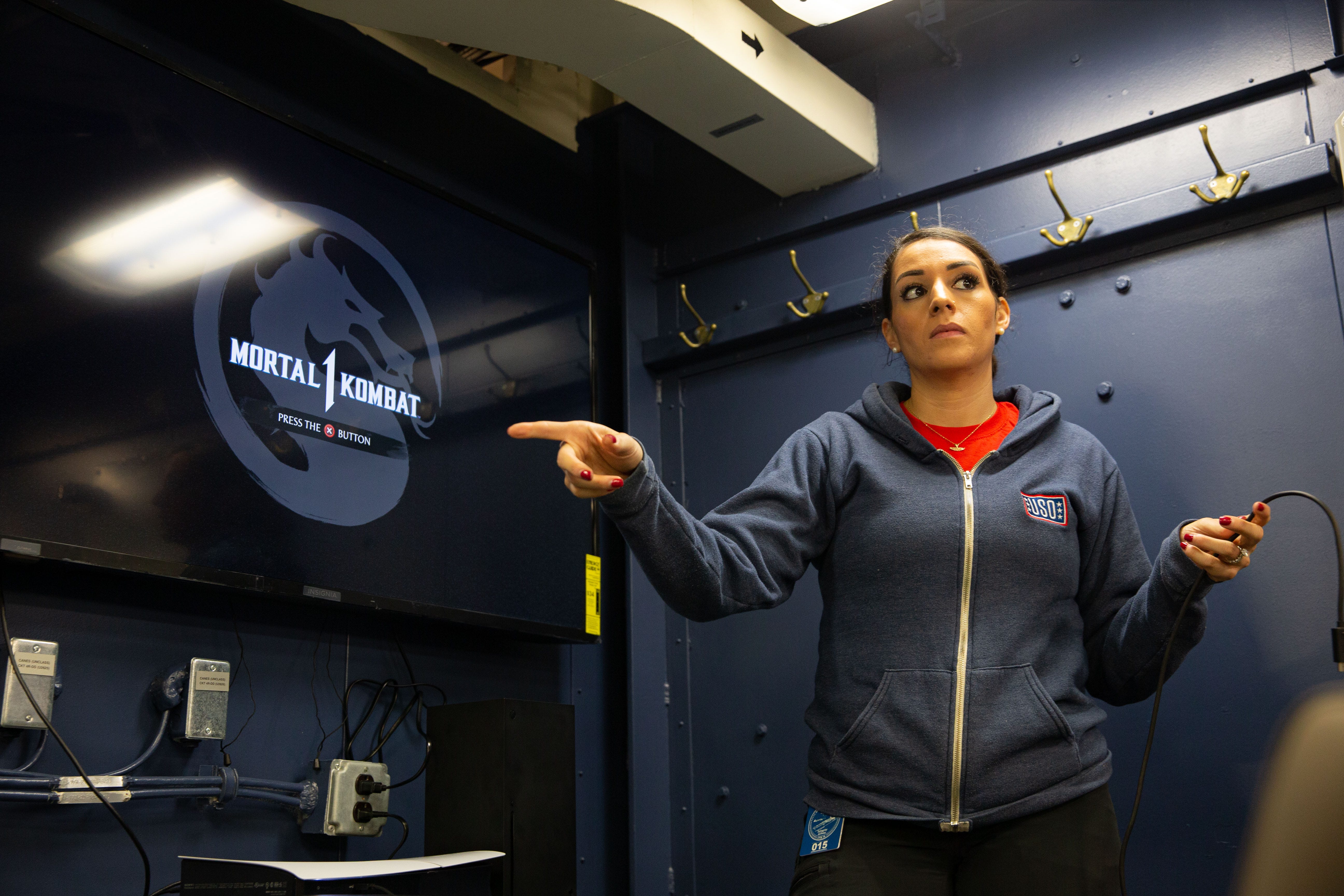 A USO employee helps to set up a gaming room on the USS Gerard Ford.