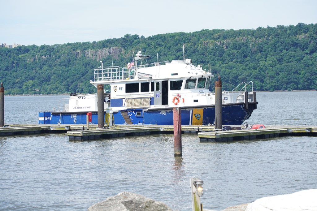 NYPD Harbor patrol boat docked at a pier.