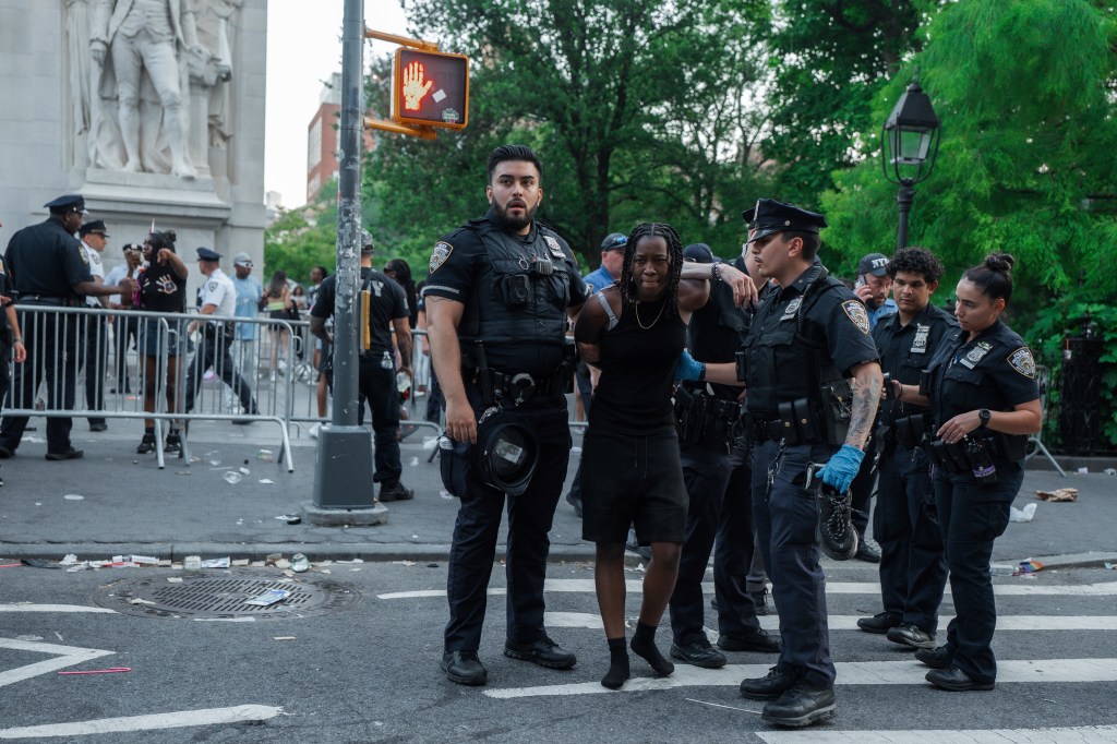 A person being arrested by NYPD officers at a New York Pride event.