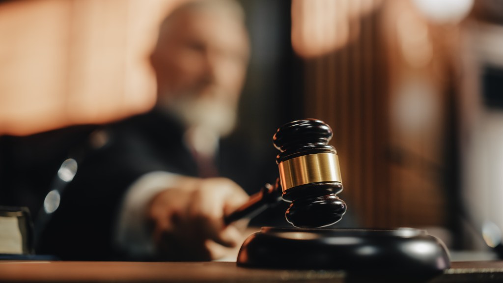 Judge's gavel about to strike a sound block.