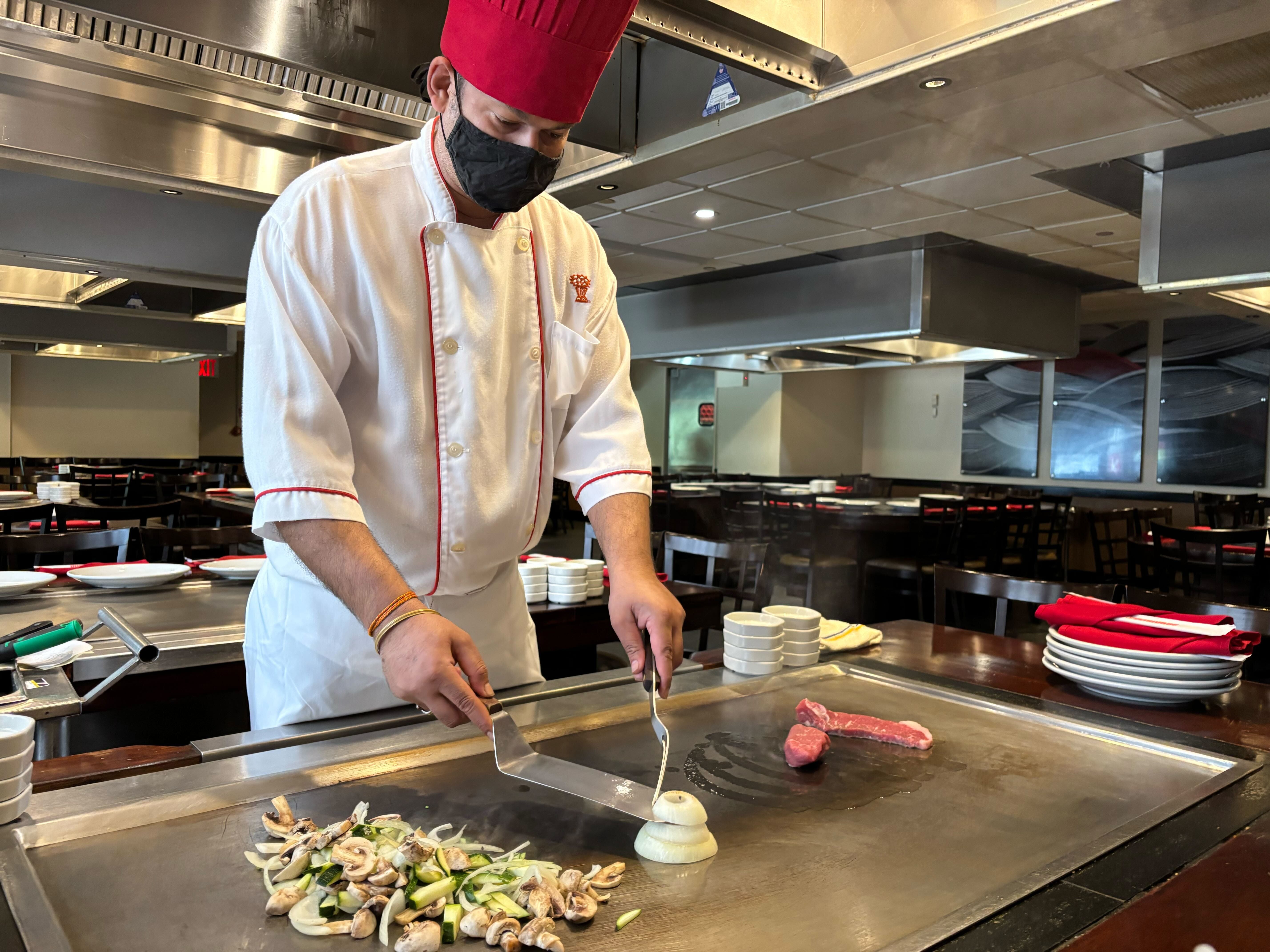 chef preparing onion volcano