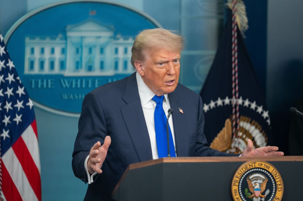 Donald Trump speaking at a press briefing.