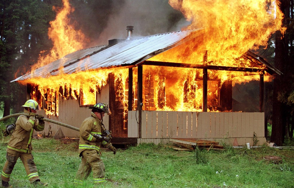 Firefighters training by burning down a building.