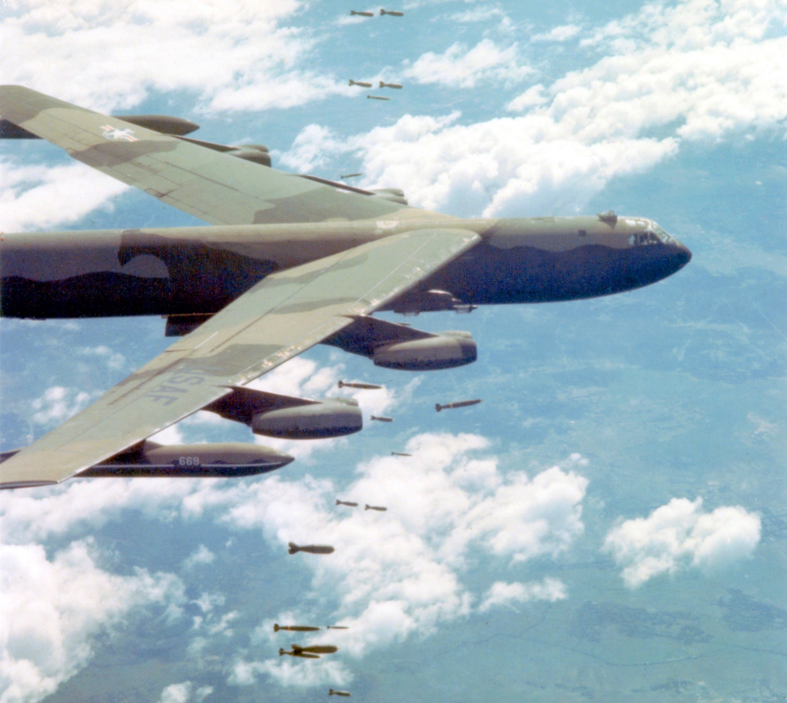 A US Air Force Boeing B-52 Stratofortress dropping bombs over Vietnam.