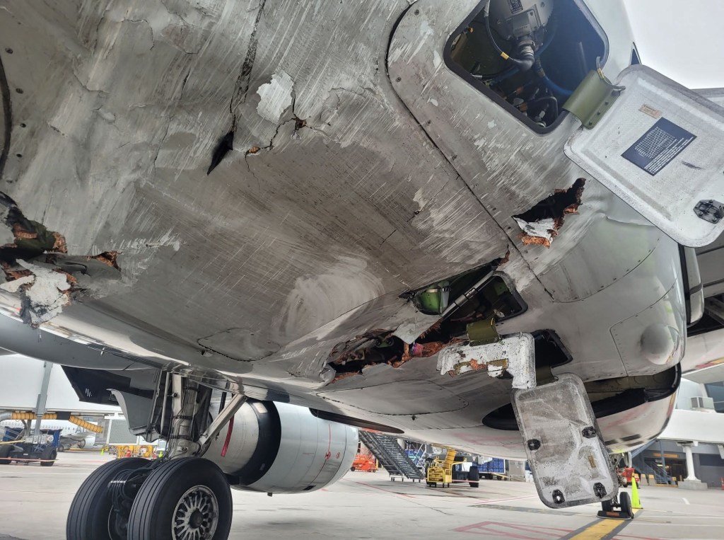 Damage to a plane's underside from a van collision.
