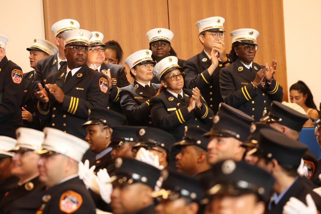 FDNY EMS promotion ceremony attendees applauding.
