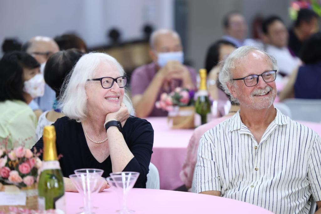 A couple sitting at a dinner table.