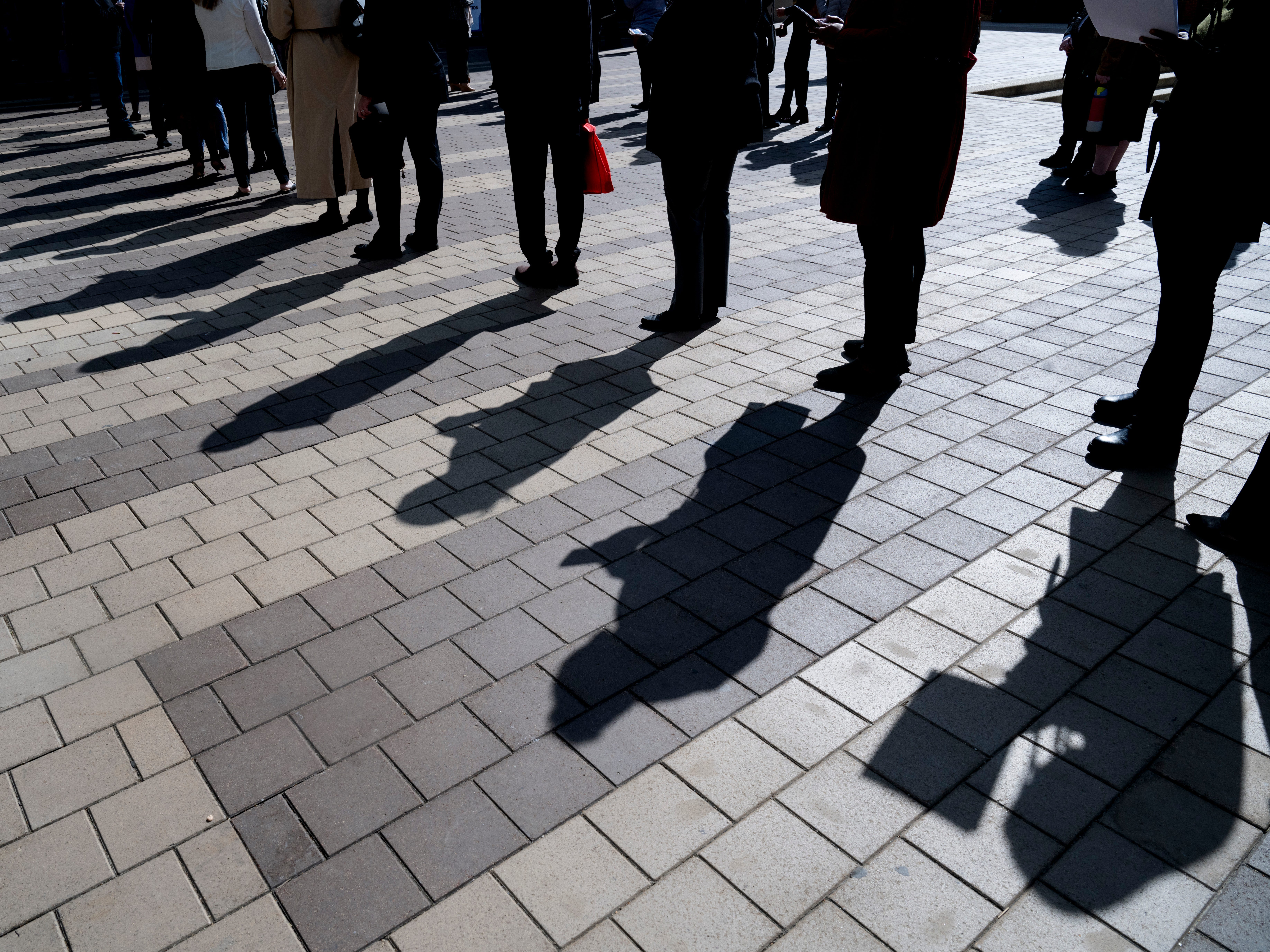Unemployed people stand in line.