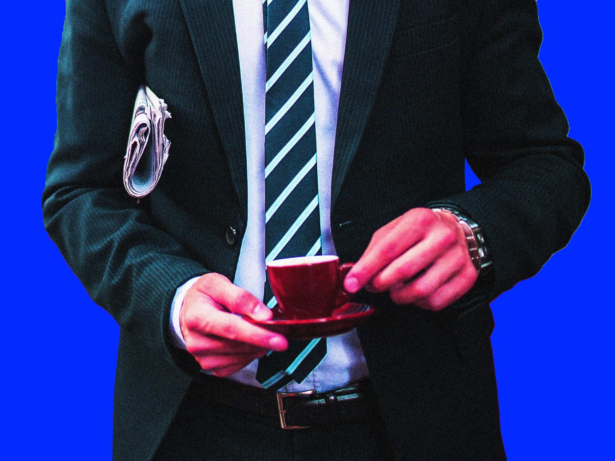 A businessman holding a newspaper and an espresso cup