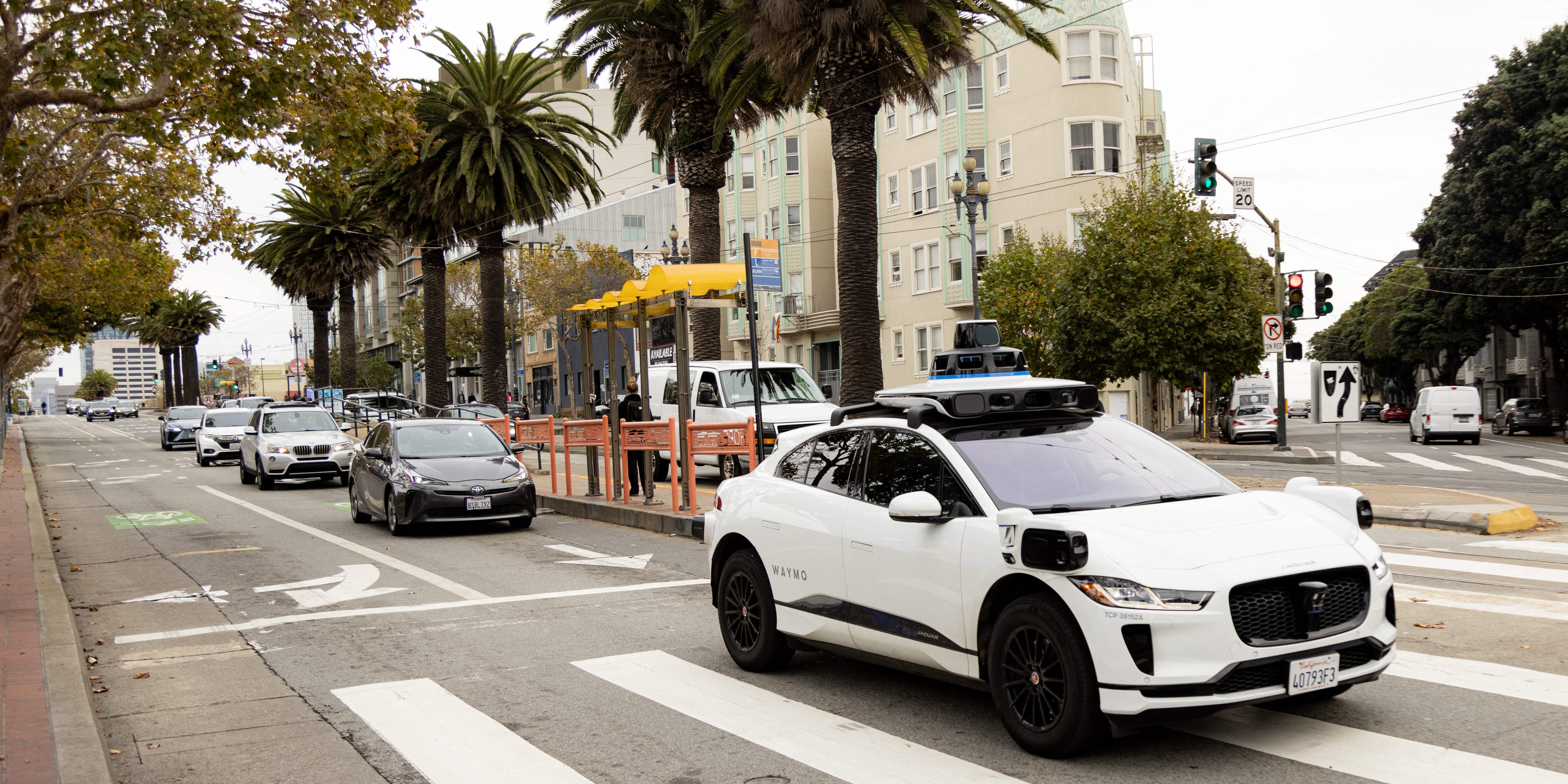 A Waymo self-driving taxi crosses an intersection in San Francisco.