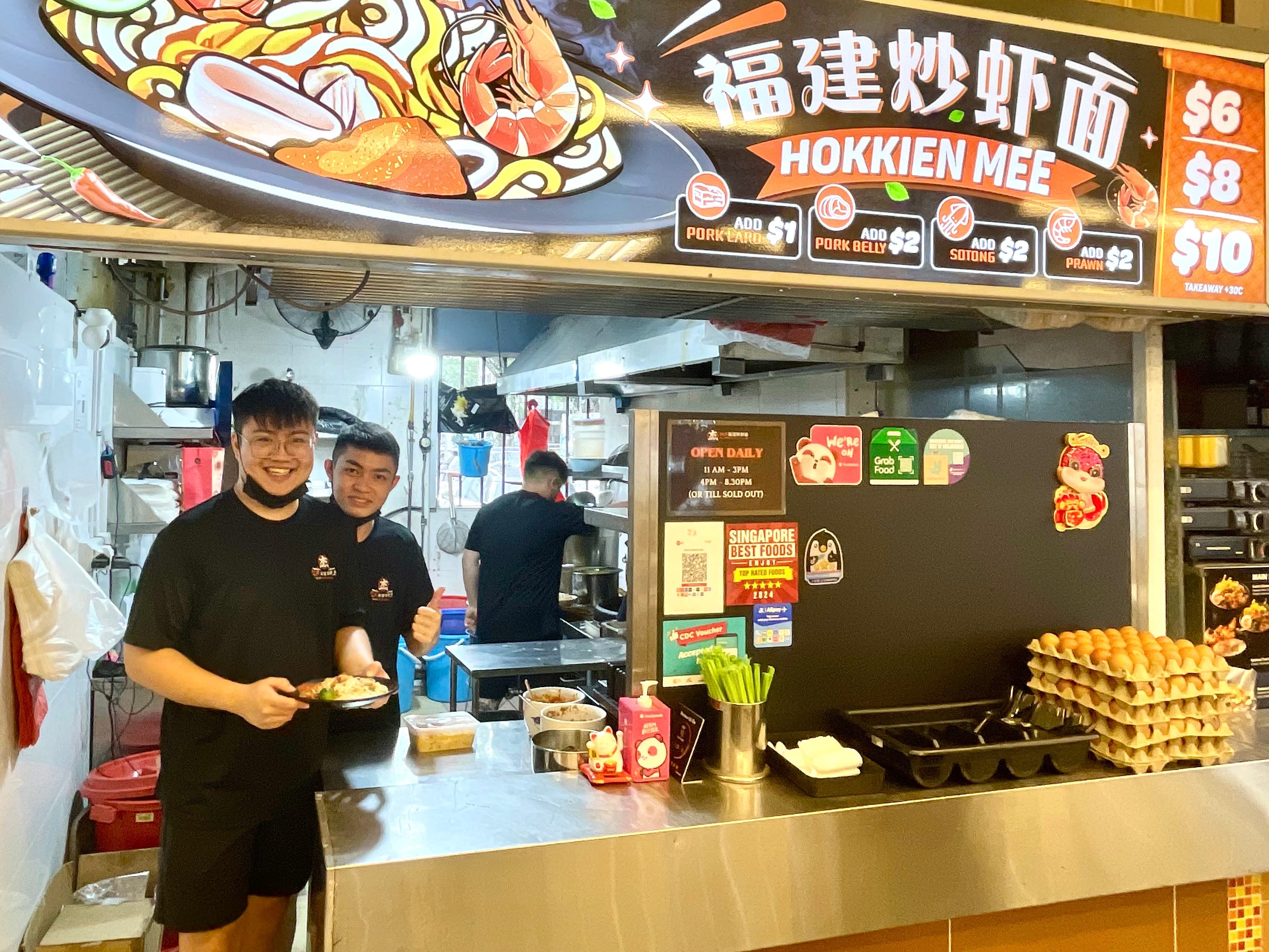 Teo Jun Jie and his staff at Ah Jie Hokkien Mee, a prawn noodle stall in Singapore.