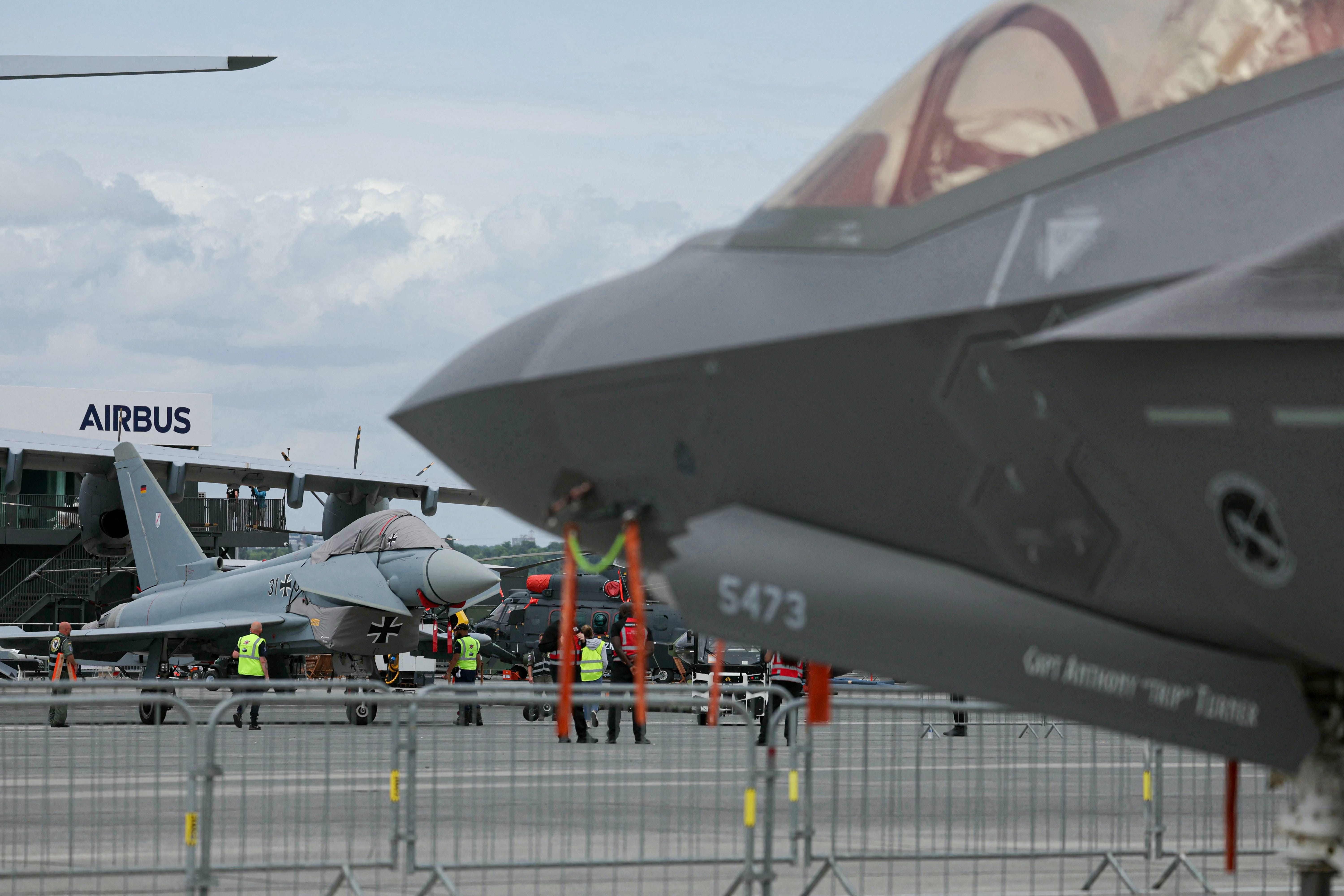 This photograph shows a German Eurofighter Typhoon jet (L) displayed during the 55th edition of the International Paris Air Show (Salon international de l'aeronautique et de l'espace - SIAE) at the ParisLe Bourget Airport, in Le Bourget, suburb of Paris on June 15, 2025.