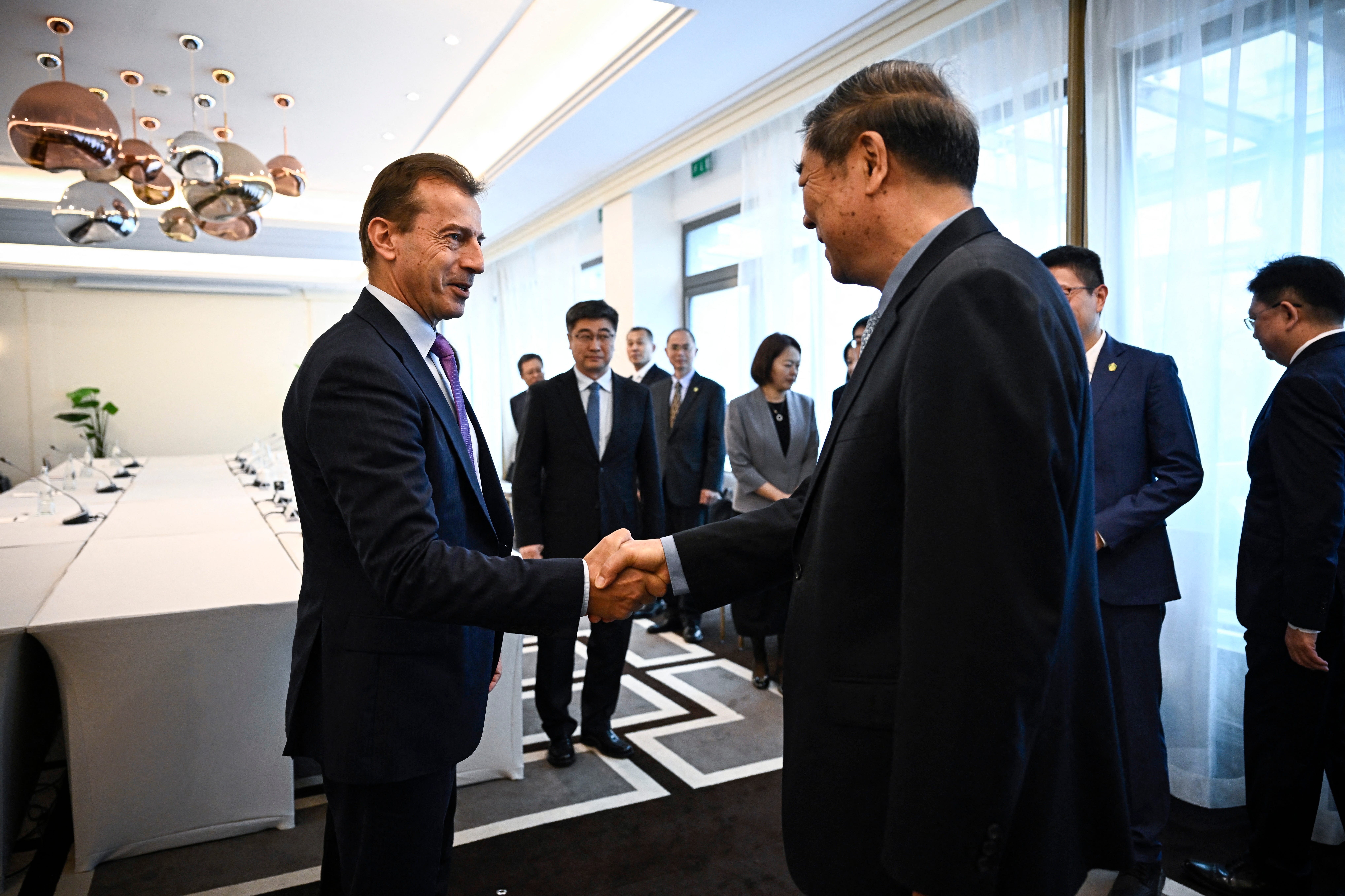 Airbus CEO Guillaume Faury and China's Vice Premier He Lifeng shake hands before a meeting at the Hotel des Collectionneurs in Paris, on May 14, 2025.