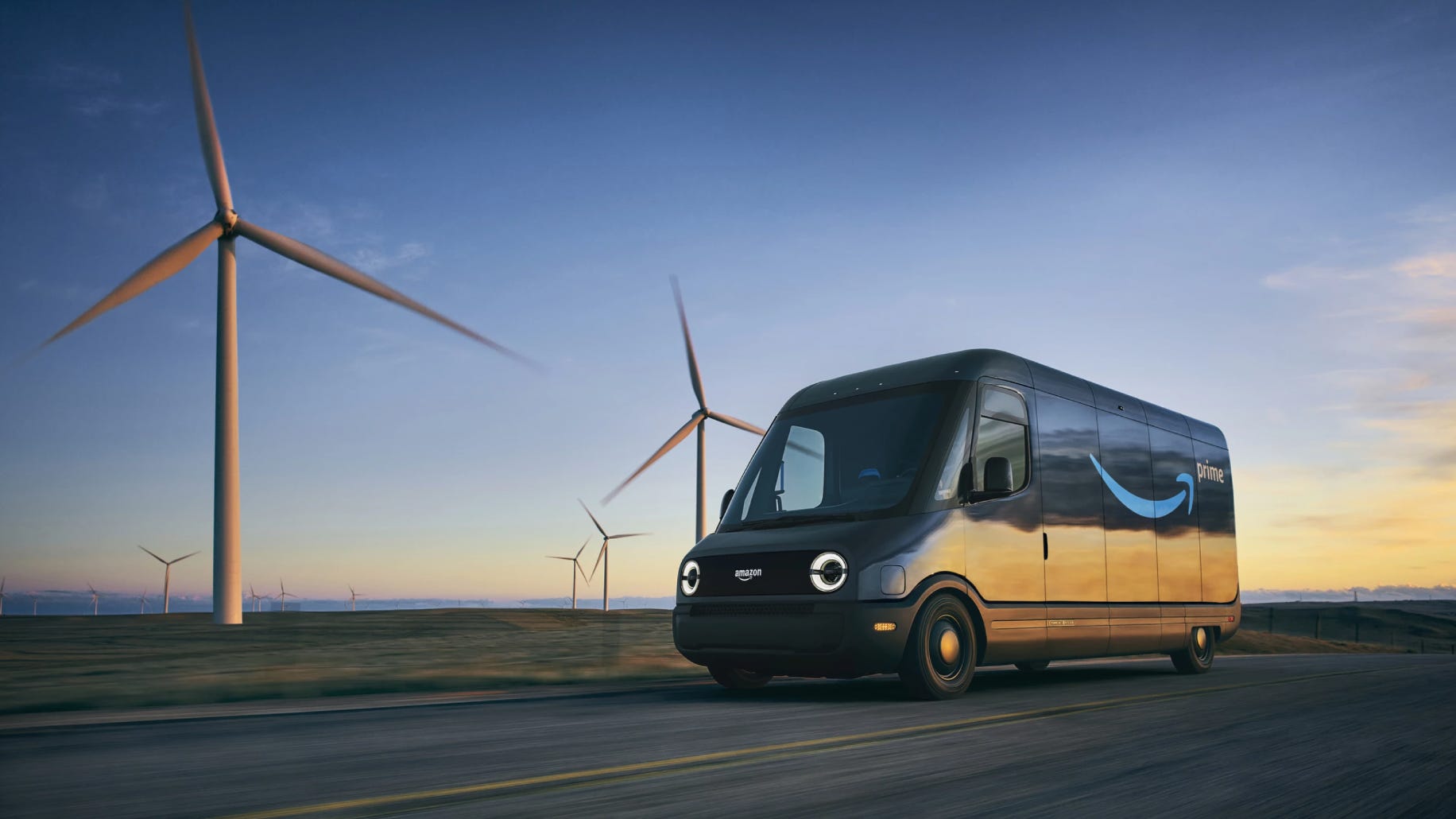 An Amazon delivery van drives past windmills at sunset.