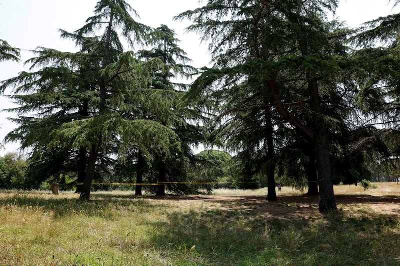 A security cordon separates the crime scene from public access inside Villa Pamphili park.