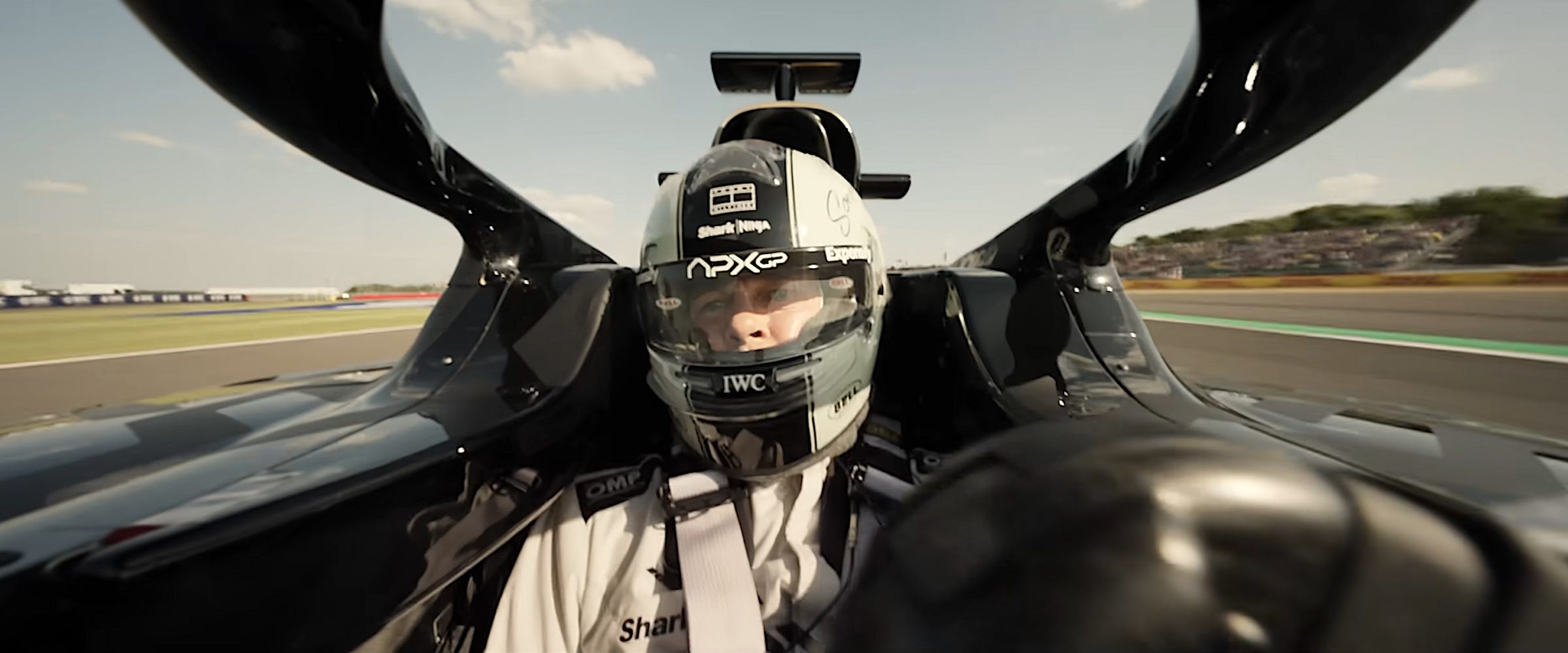 Brad Pitt driving on an F1 race track as Sonny Hayes in "F1."
