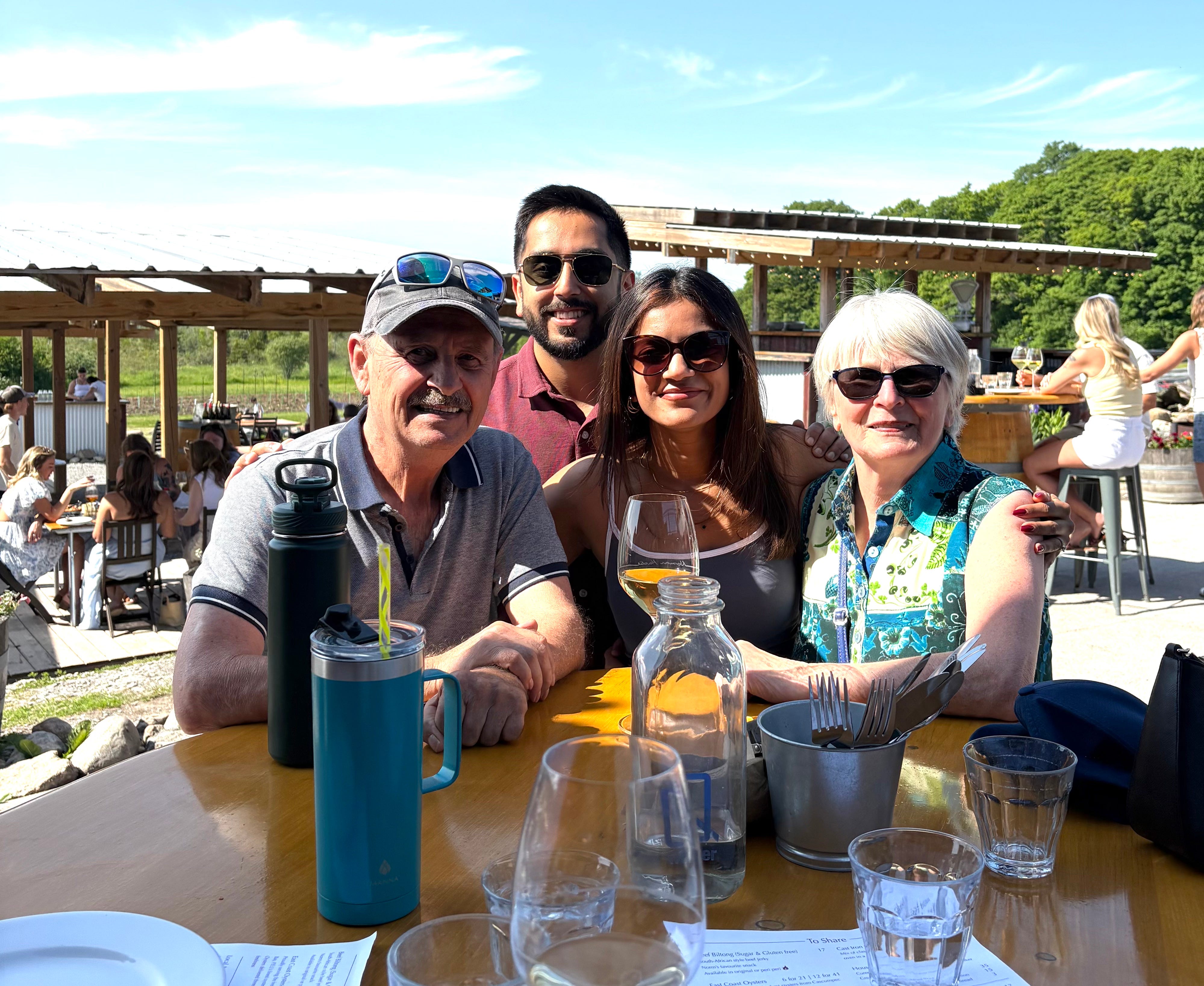Vaishali Gauba sits with her husband and two Airbnb hosts, Judy and Evan.