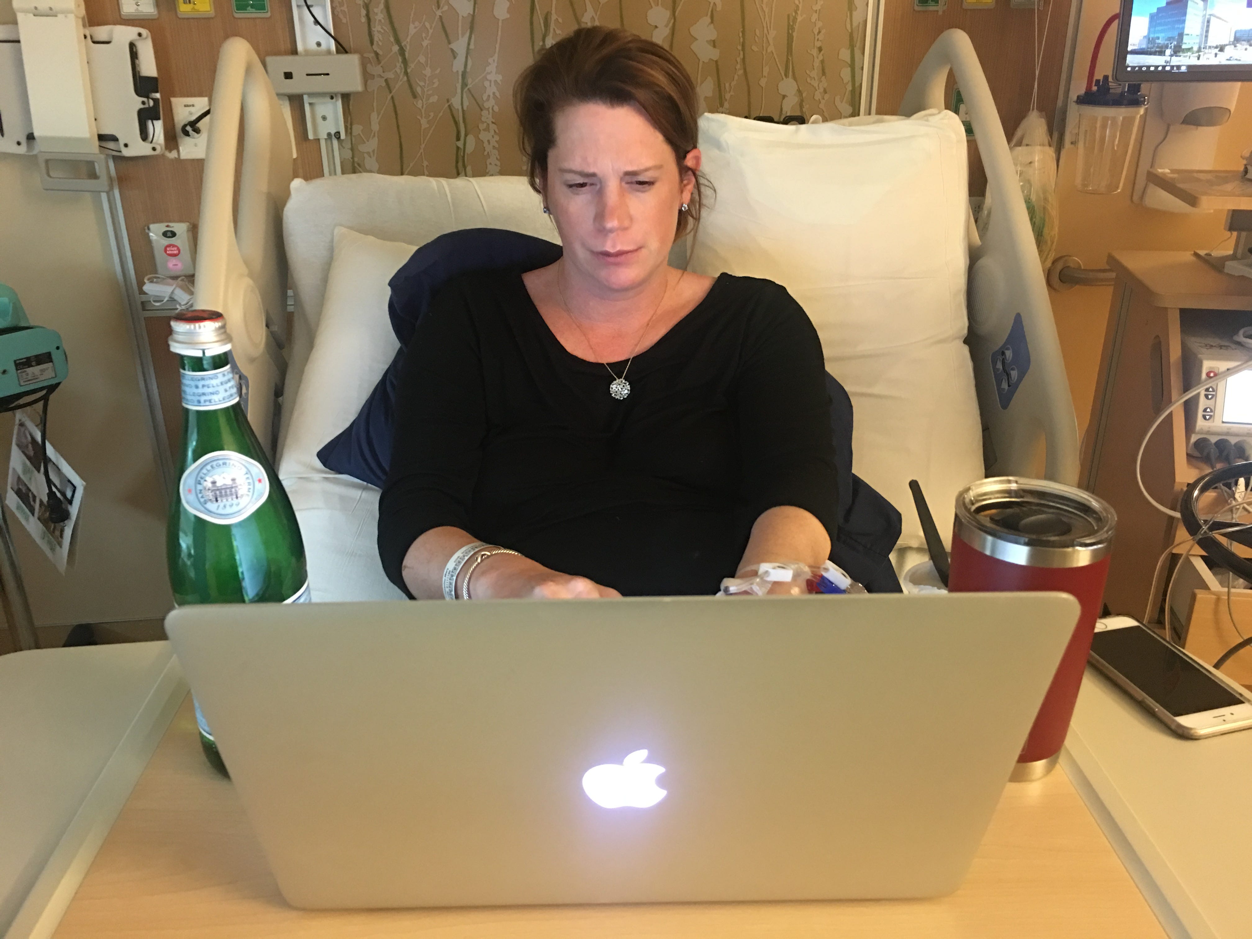Woman working at hospital bed