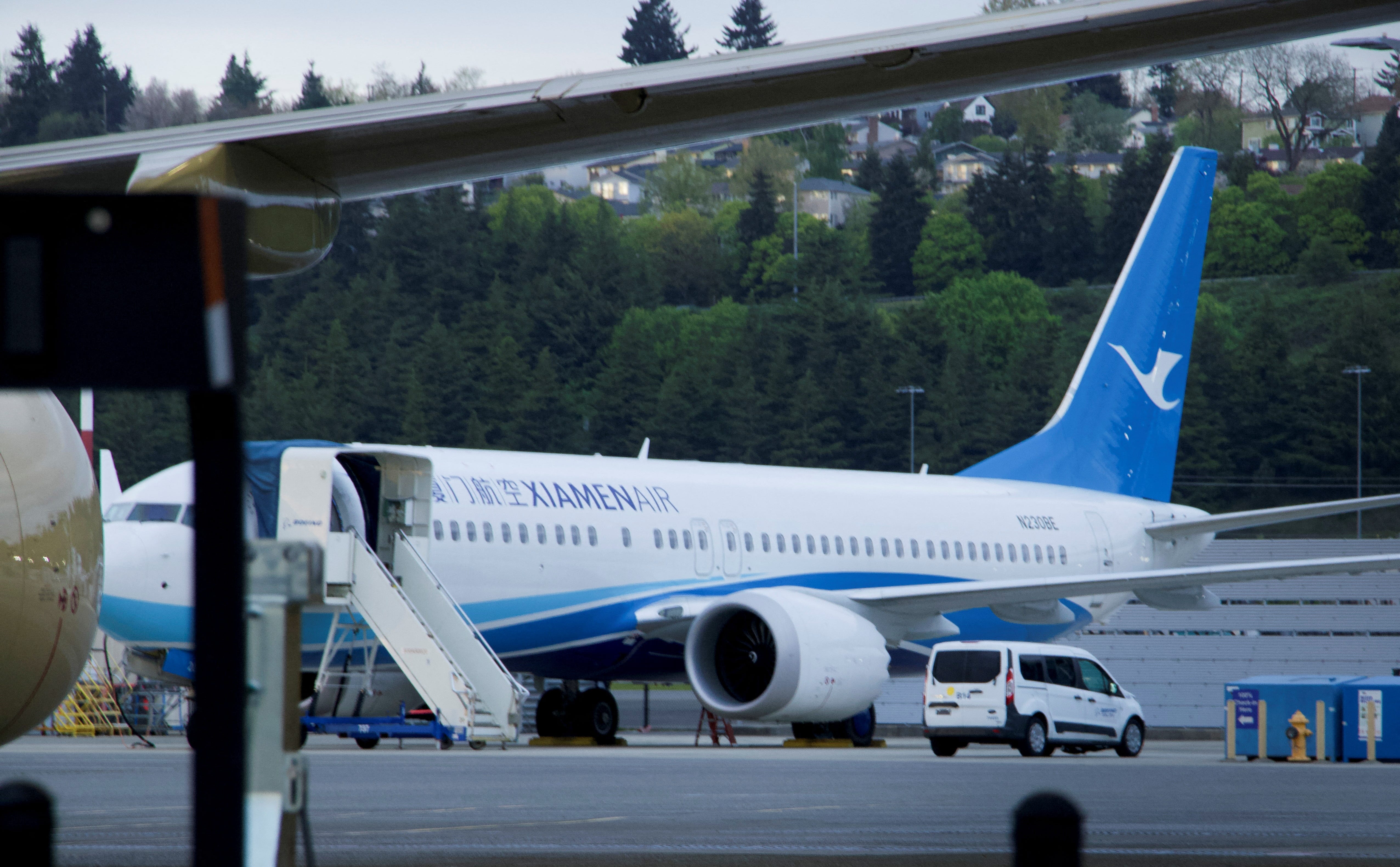 A new Boeing 737 MAX for Chinese customer Xiamen Airlines sits at King County International Airport, in Seattle, Washington, U.S., April 19, 2025 after deliveries to the country were halted in early April following steep tariffs imposed by the U.S. Picture taken through a chain link fence.