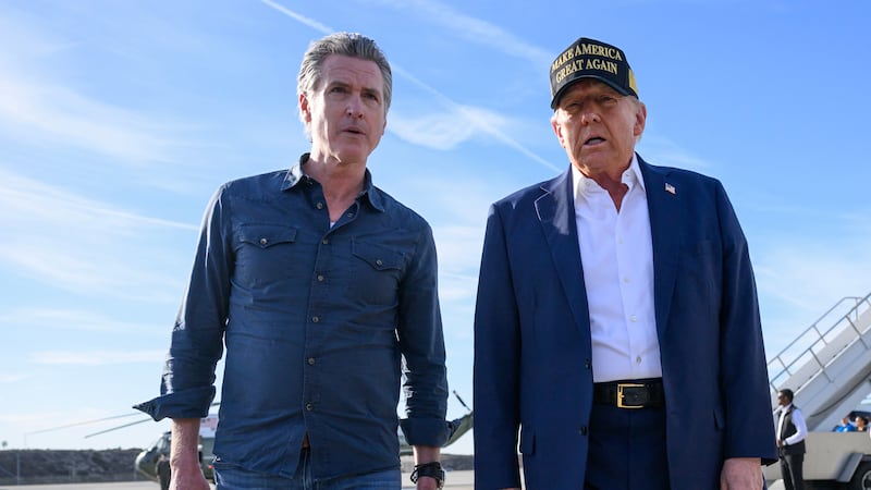 California Gov. Gavin Newsom walks with President Donald Trump during the president's visit to California in January.