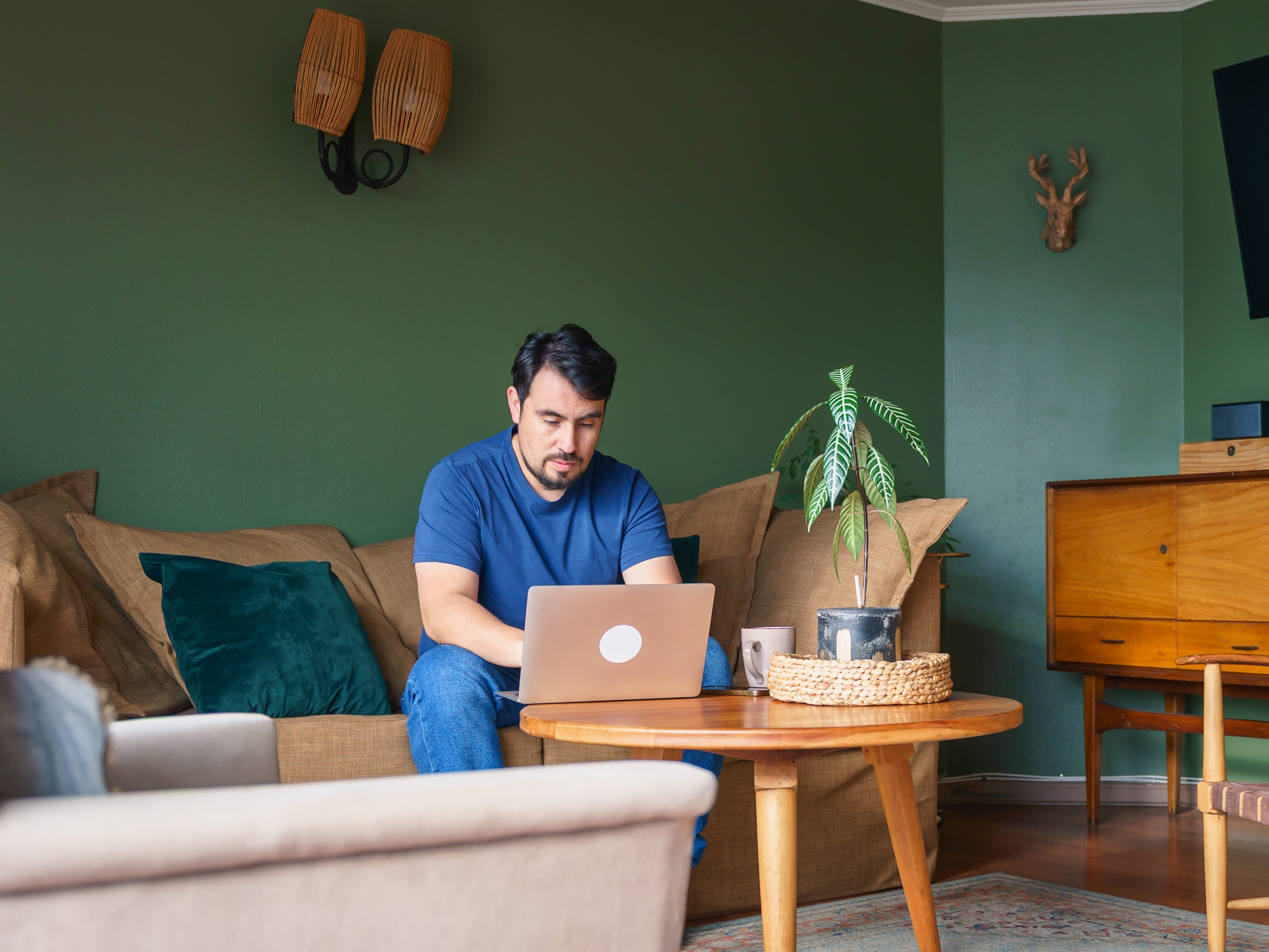 a man working on his computer in a living room