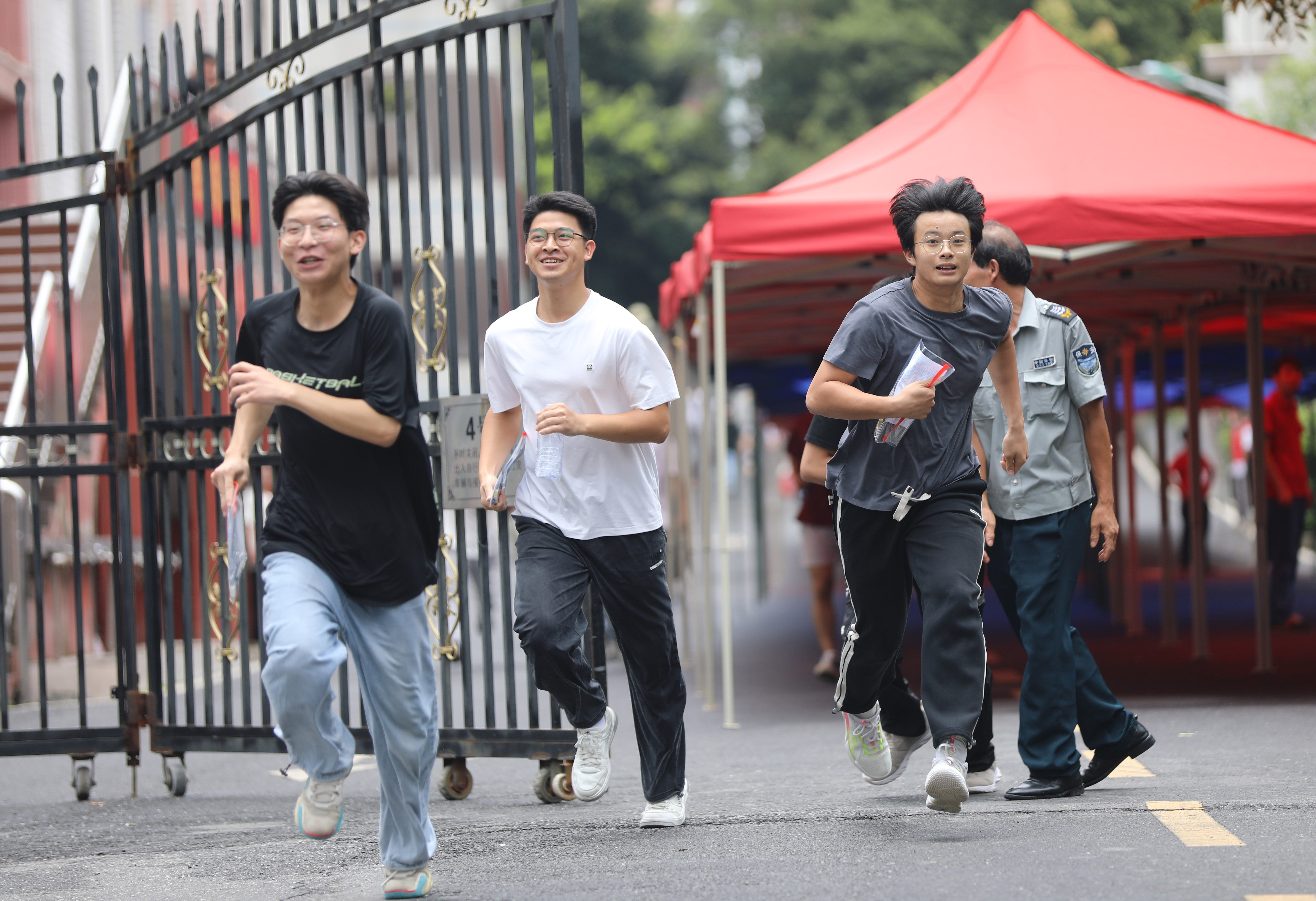 YONGZHOU, CHINA - JUNE 09: Gaokao candidates run out of an exam venue after the national college entrance exam, or 2025 gaokao, on June 9, 2025 in Yongzhou, Hunan Province of China.